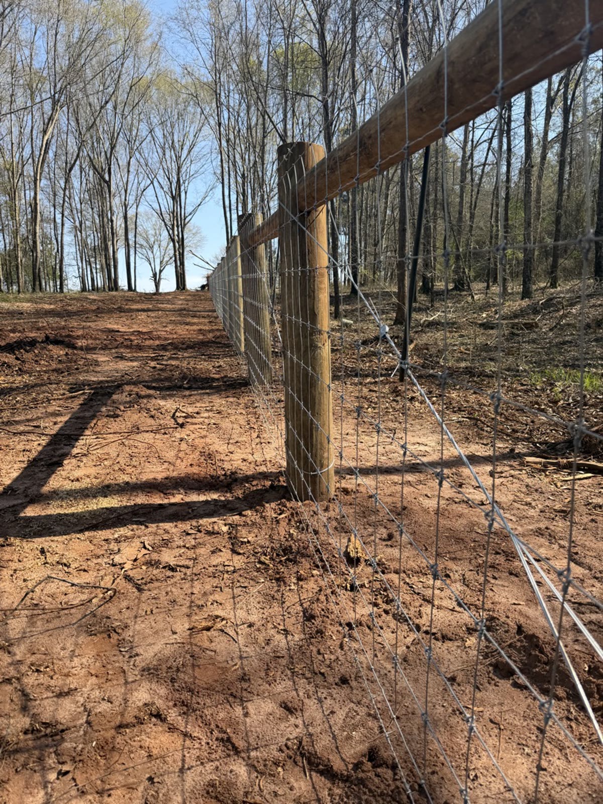 New fence installation on red Georgia clay